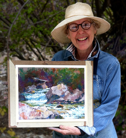 Amy Winton Holding a Painting While Smiling